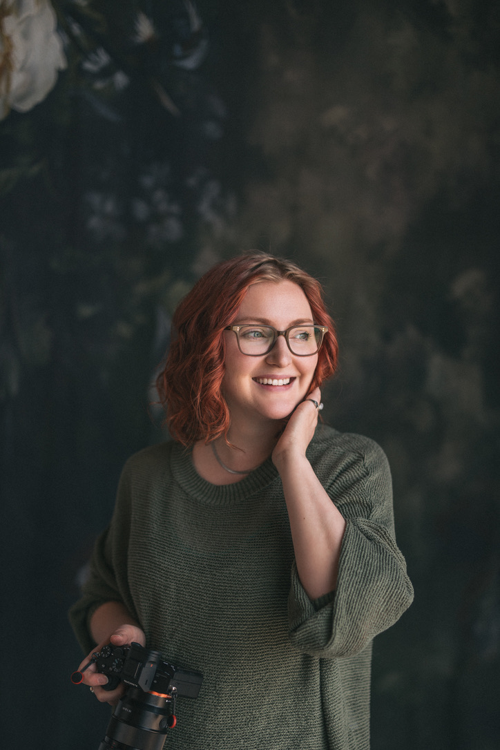 A photo of Amanda, the business owner of Amanda Bachelot Photography, holding a camera